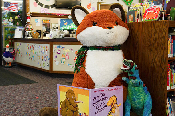 Image of a teddy with a book